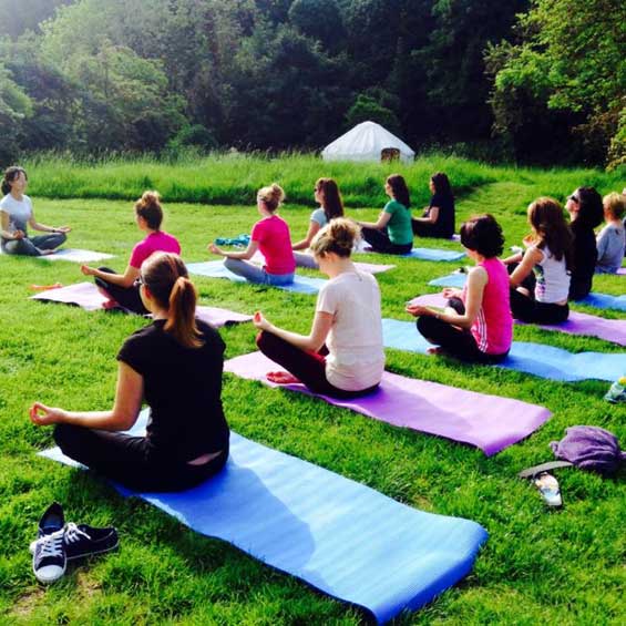 Group of people practicing Yoga and Meditation in the great outdoors