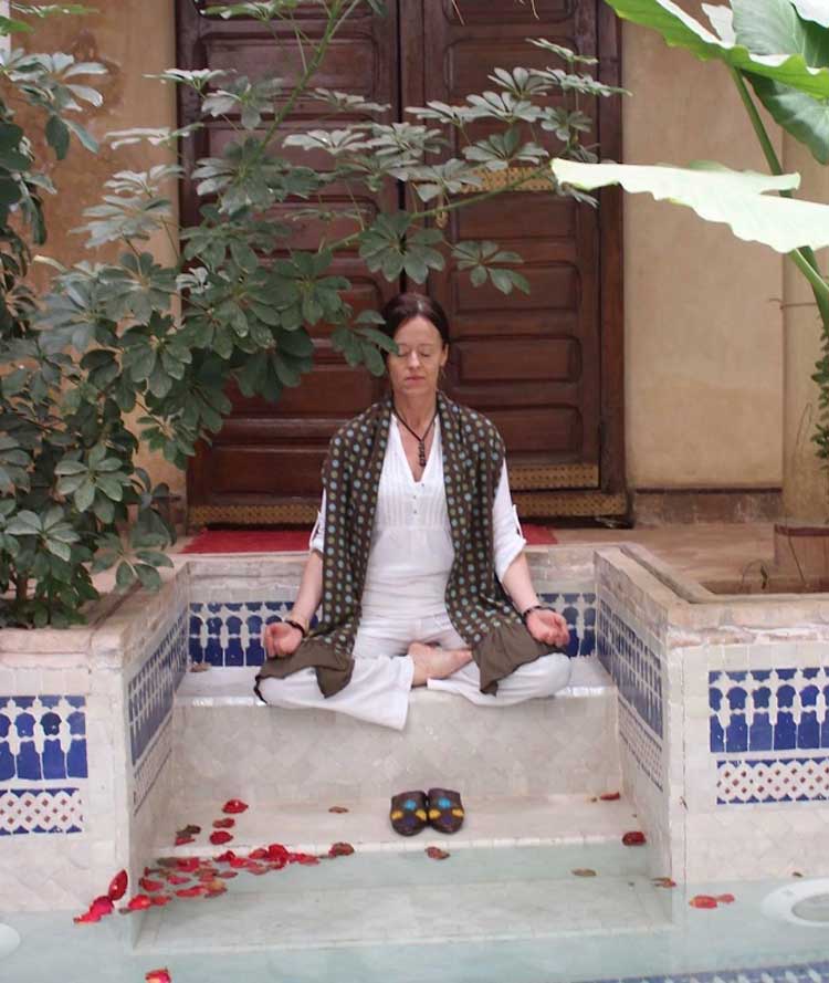 Finola practicing meditation in a tranquil and serene place