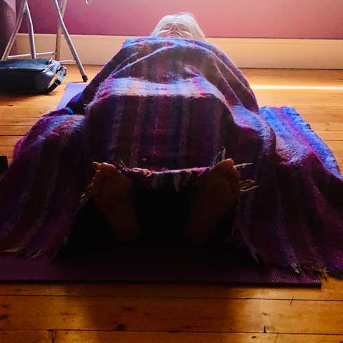 Client participating in a restorative Yoga session at Siog Holistic