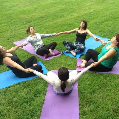 Group of people participating in an outdoor Yoga class